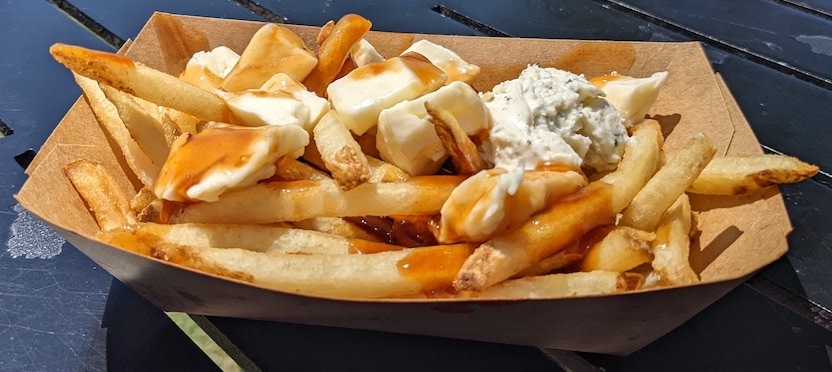 Poutine in the Canada pavilion at the EPCOT Food and Wine Festival - Frayed Passport