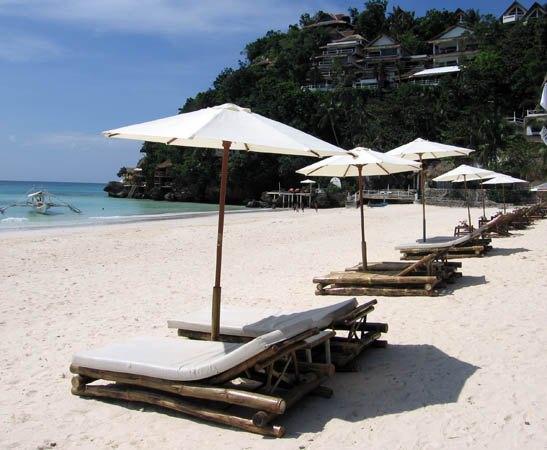 Are You Afraid of Retirement? Tips from Retire Early Lifestyle - Frayed Passport - gorgeous beach with umbrellas and chairs