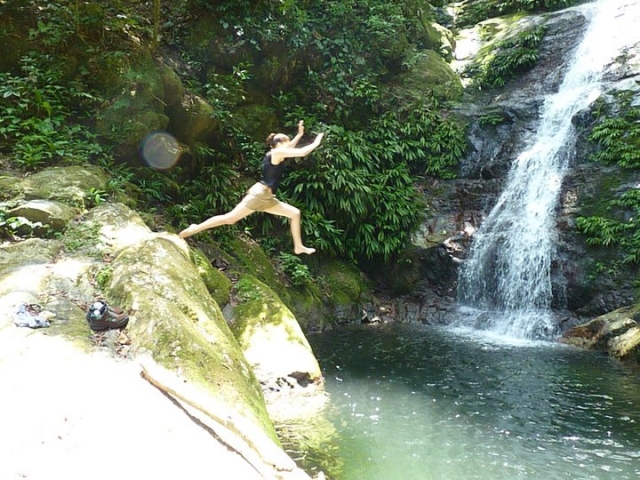 Leaping into a waterfall in Honduras