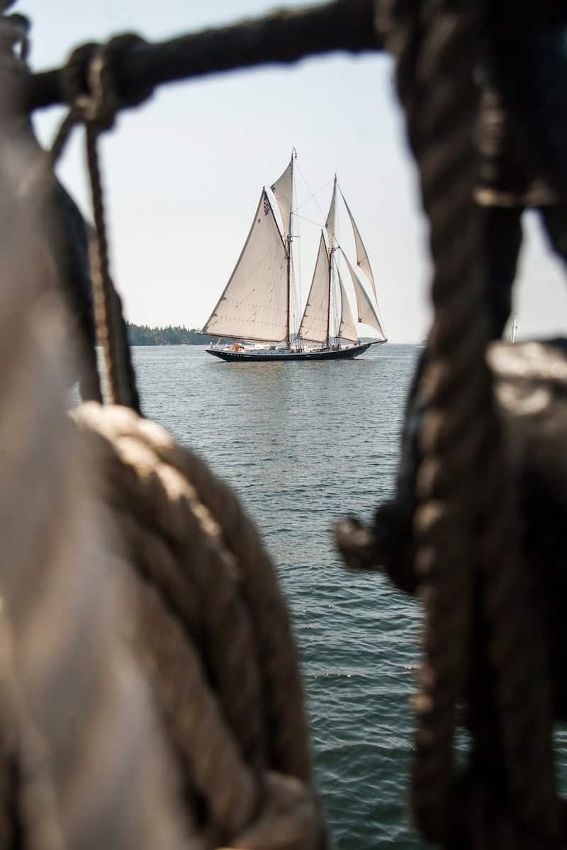 a sailboat sailing in the ocean on a sunny day