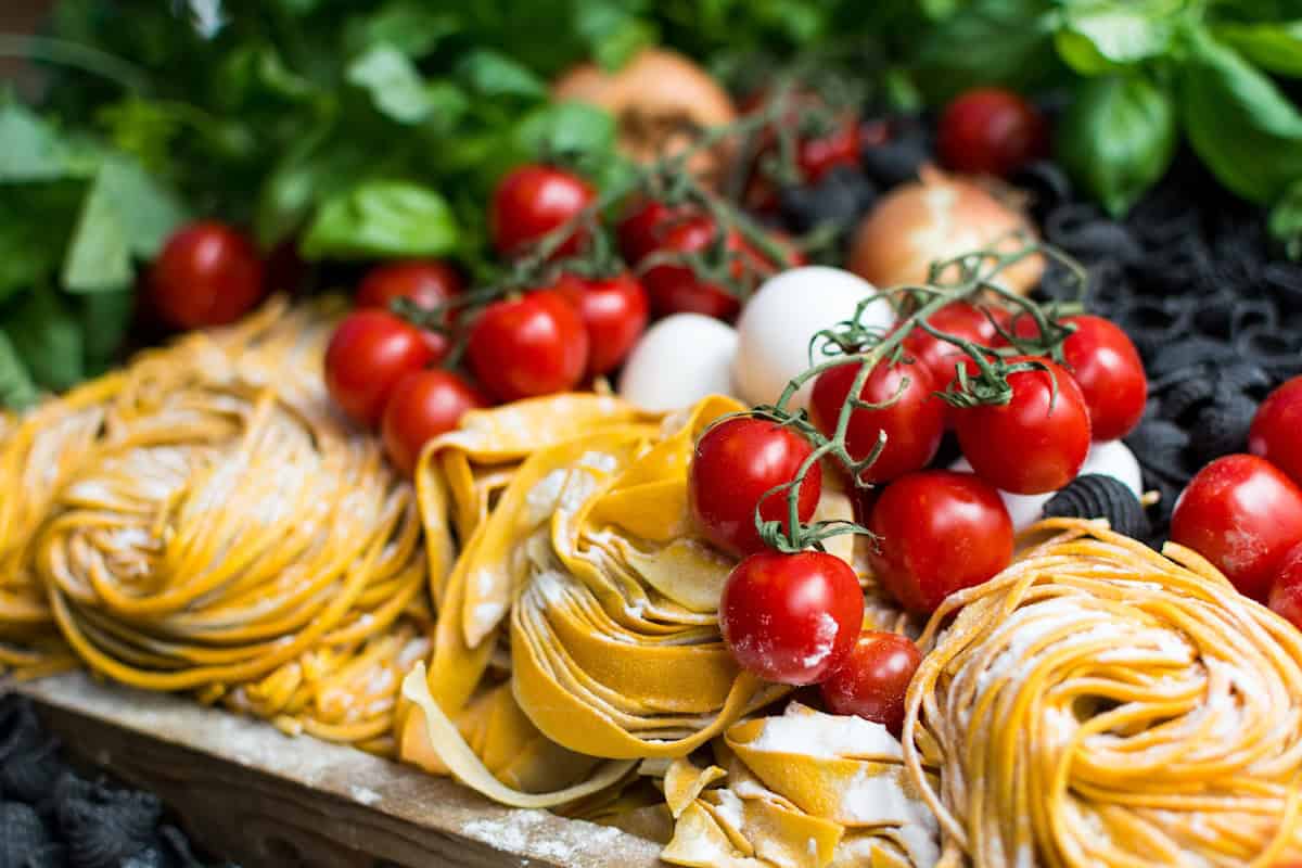 Photo by Jakub Kapusnak yellow pasta and cherry tomatoes