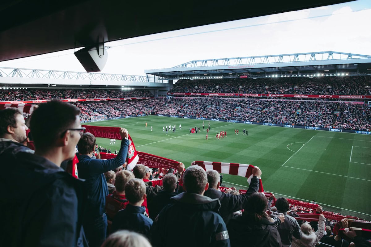 Fans watching a soccer match at the stadium