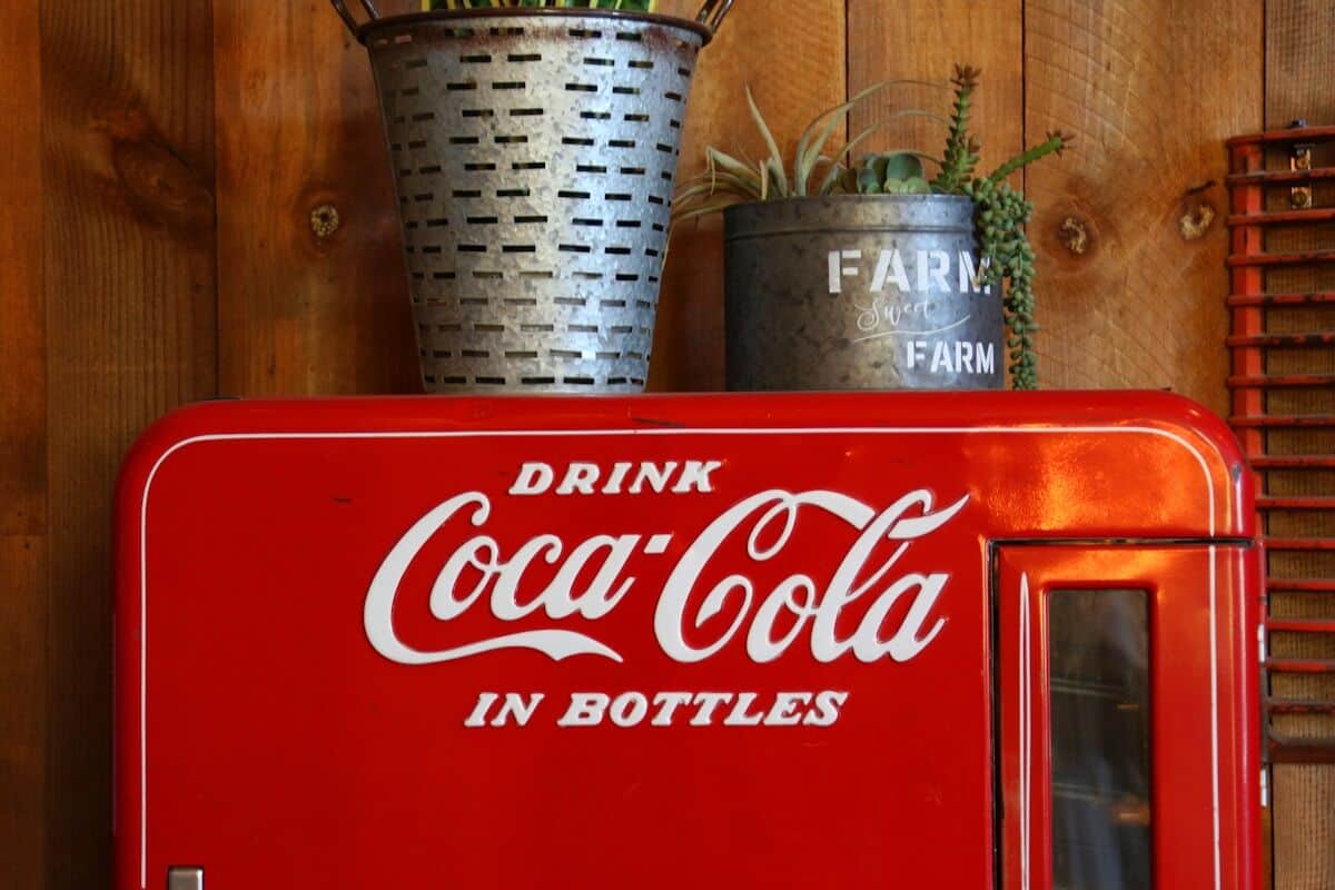 Vintage coca-cola cooler with plants on top