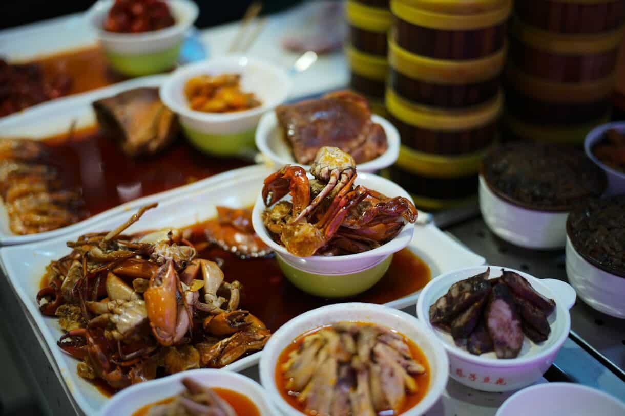 Why a guided food tour is the ultimate way to travel - Frayed Passport - Platter of assorted seafood and meats in sauce