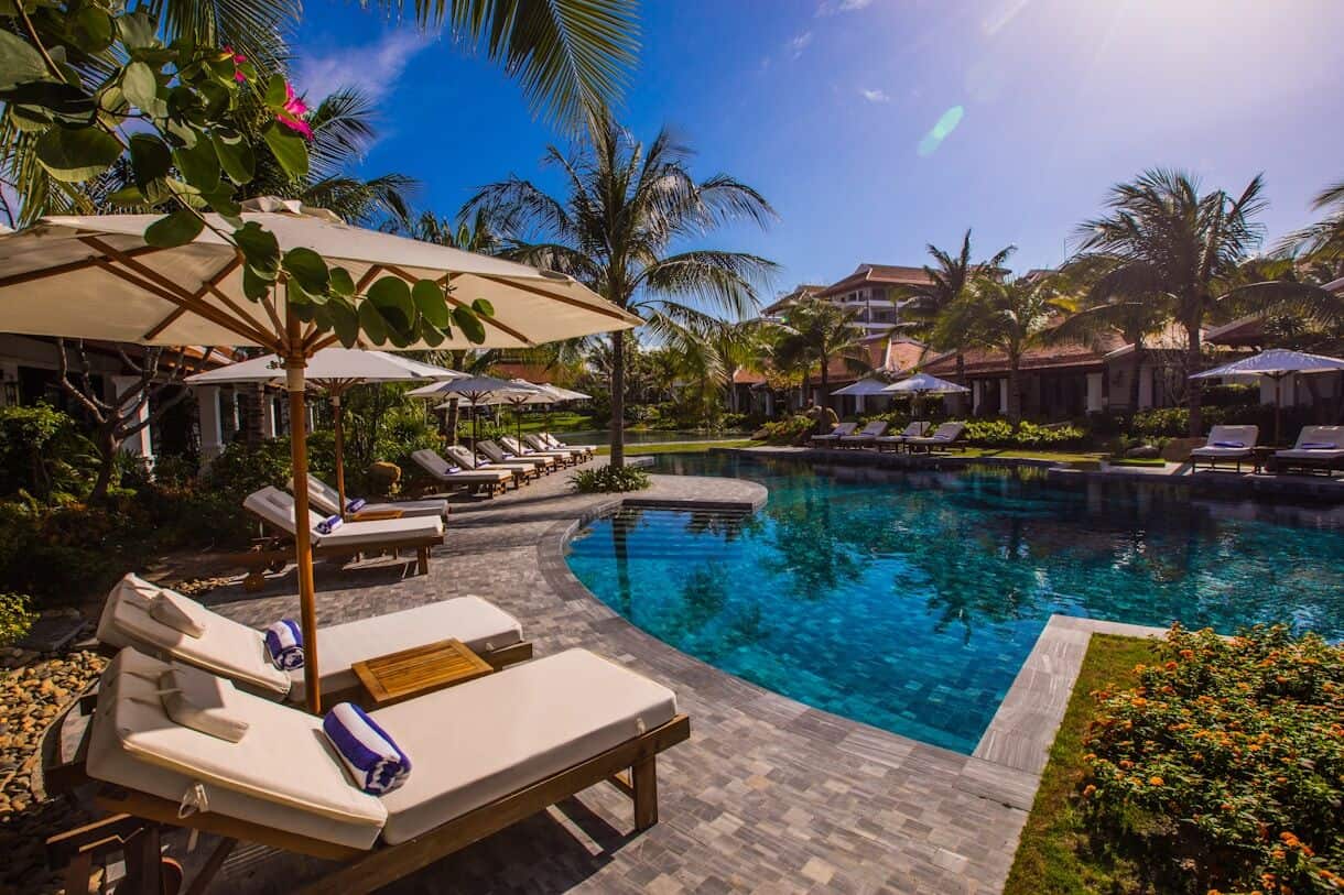 Uncovering Unique Stays for Your Next Adventure - Frayed Passport - white and brown lounge chairs beside swimming pool during daytime