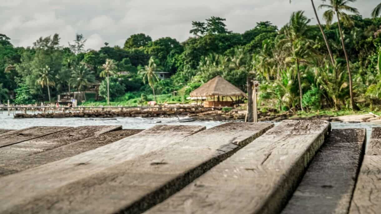 Calming Locations That Prove A Trip To Asia Doesn't Have To Be Hectic - Frayed Passport - Koh Kood, Thailand - a stone wall with a building and trees in the background