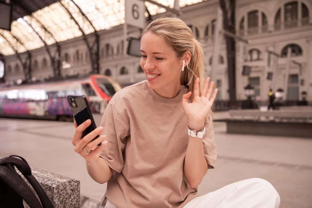 Moving Abroad? Do Not Trust a Free App With These Documents - Frayed Passport - a woman sitting on a bench using a cell phone