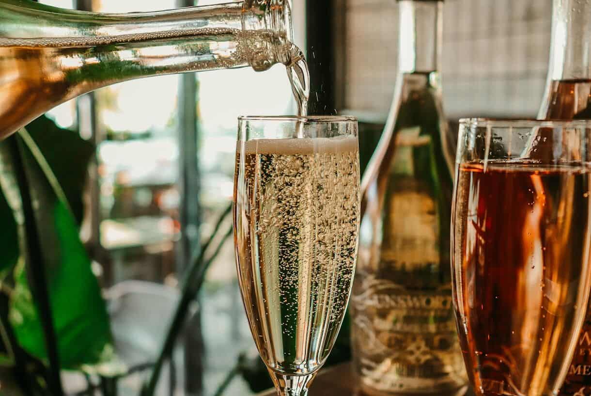 Champagne grapes are harvested by hand - Frayed Passport - clear wine glass with brown liquid