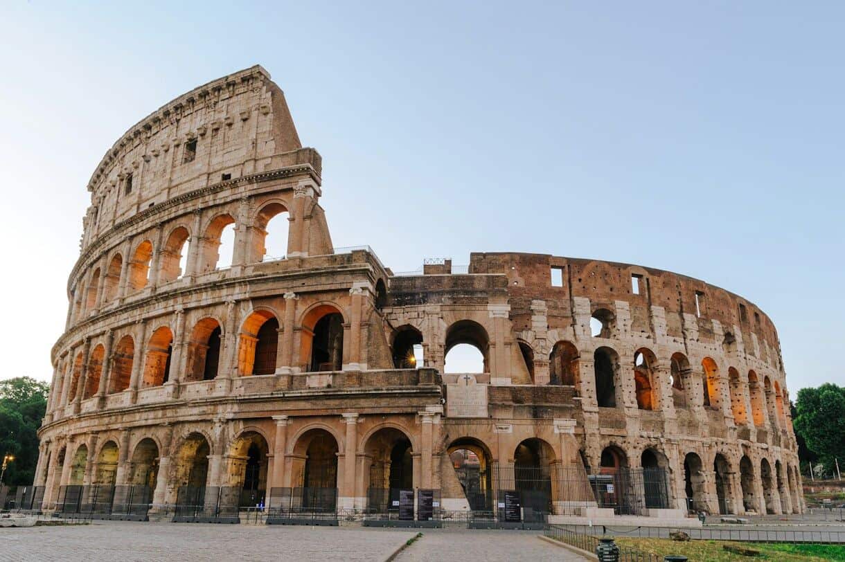 The Colosseum in Rome under a clear sky during the golden hour
